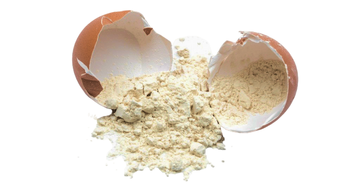 Cracked eggshell with spilled flour.