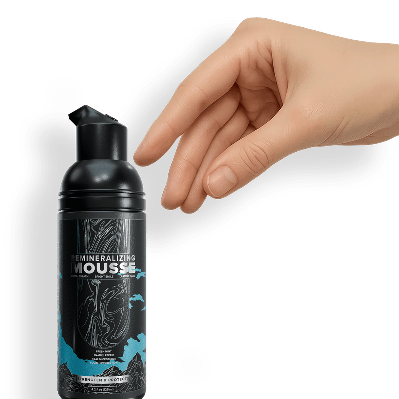 Hand reaching for Remineralizing Mousse