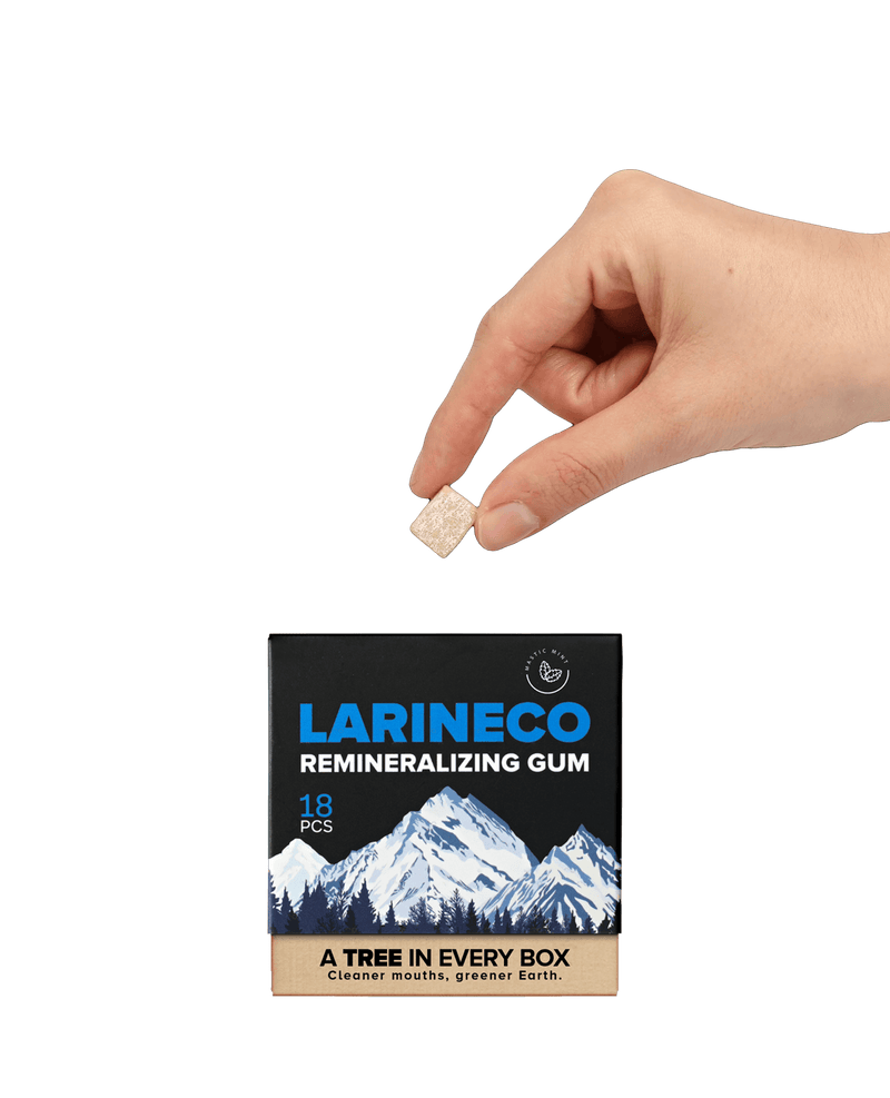 Larineco remineralizing gum being held, box with mountains visible